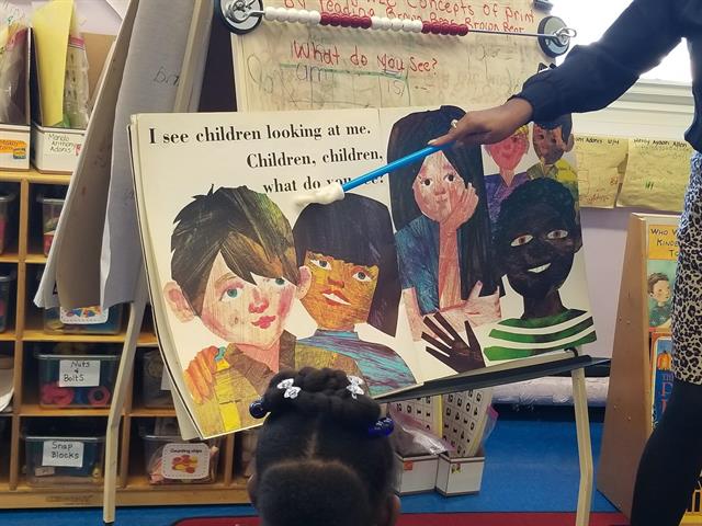 teacher pointing to storybook teacher pointing to storybook
